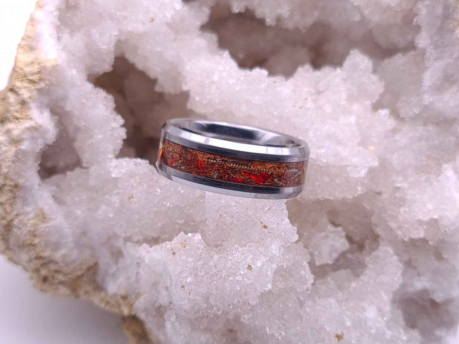 Tungsten ring with brass shavings, guitar string and crimson opal, finished with copper pigment